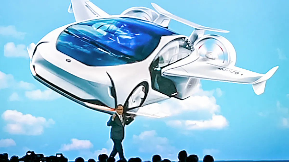 Toyota President & CEO Akio Toyoda with a future car concept