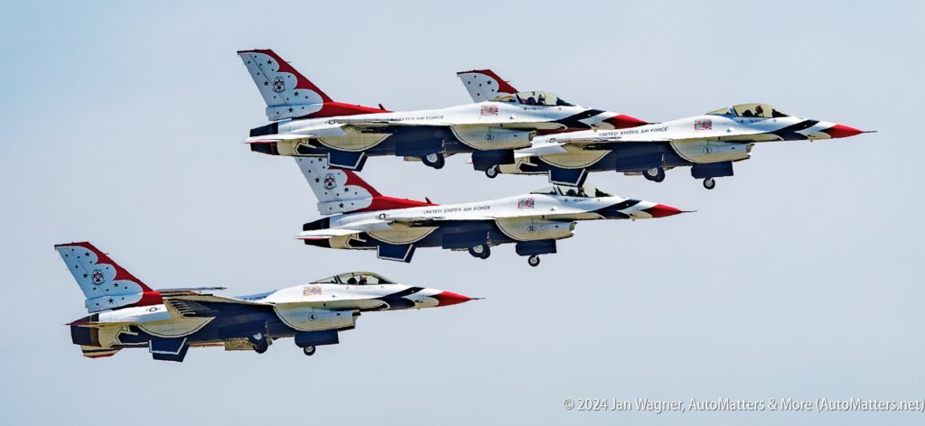 Four U.S. Air Force Thunderbirds F-16 fighter jets fly in close formation against a clear sky.