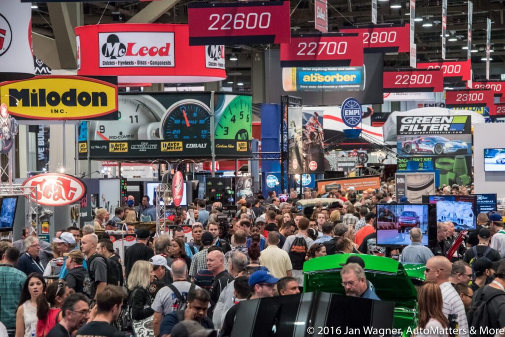 A crowd of people at an auto show.