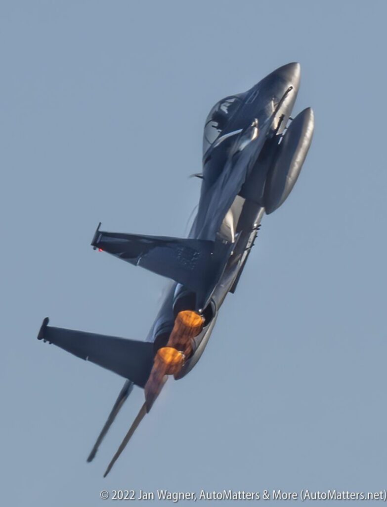 A fighter jet flying through the air with smoke coming out of it.
