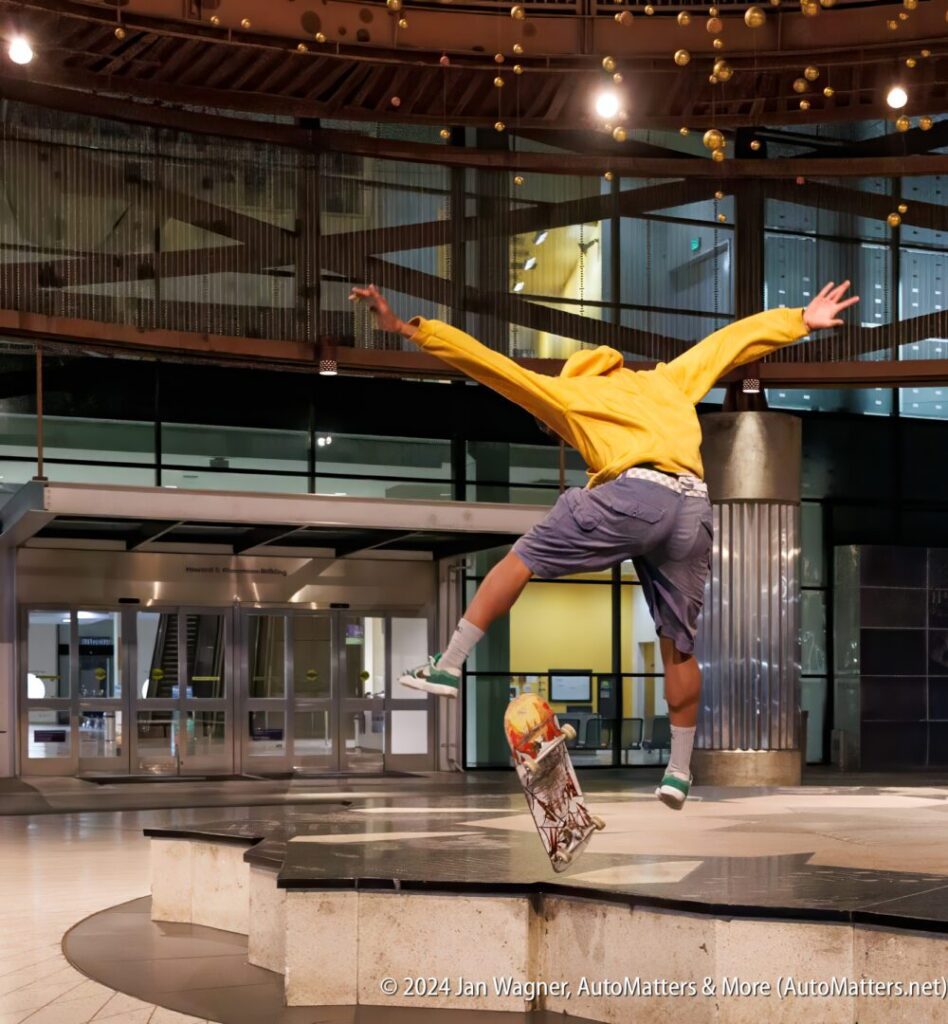 A person jumping in the air with a skateboard.