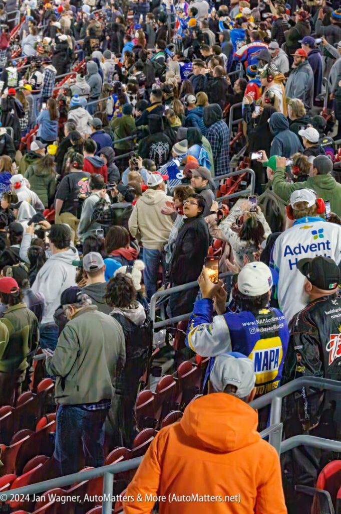 A crowd of people at a nascar race.