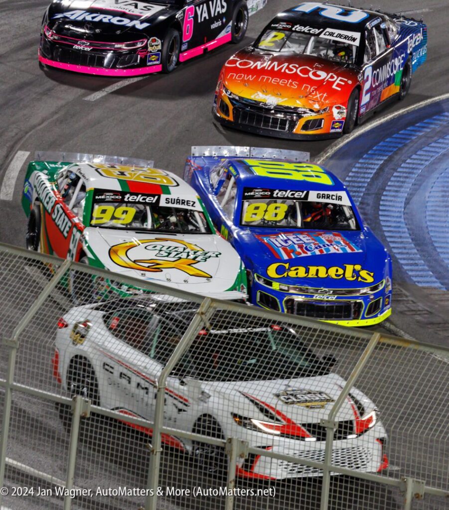 A group of race cars on a track.