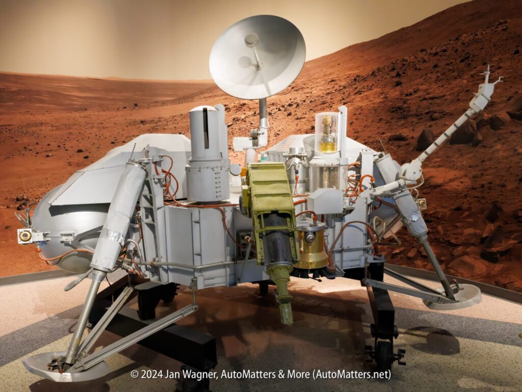 The mars rover is on display in a museum.