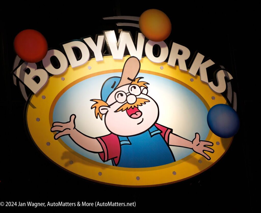 A sign with the word bodyworks on it.