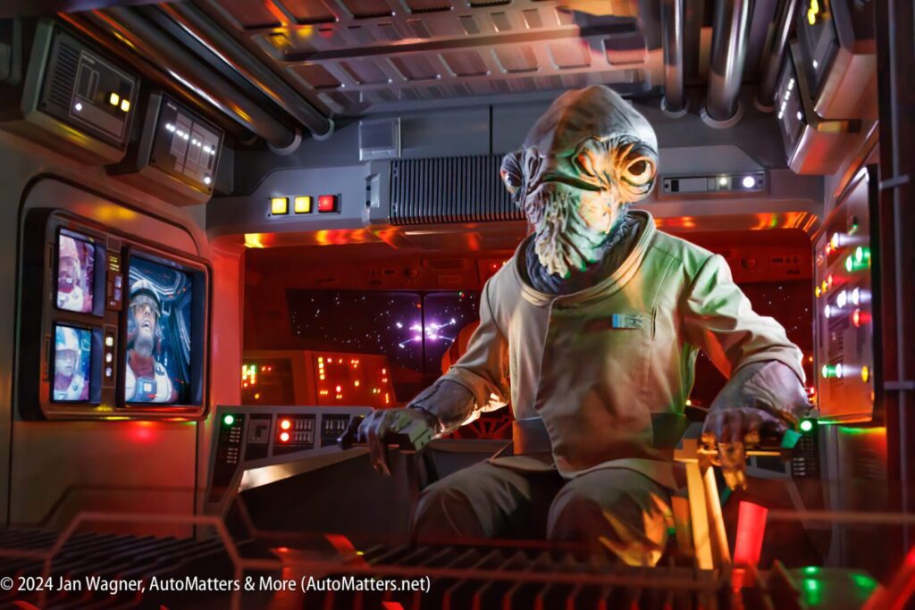 A star wars character sits in the cockpit of a spaceship.