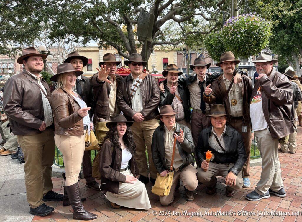 A group of people dressed in indiana jones hats posing for a picture.