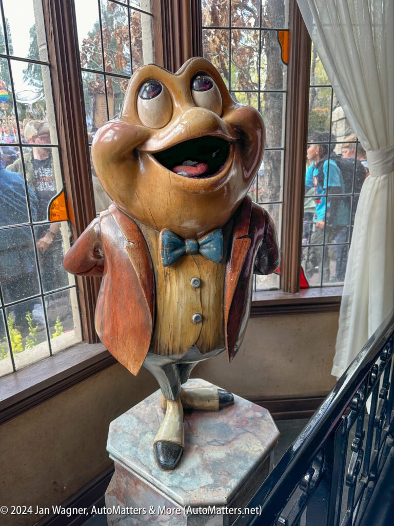 A statue of a frog with a bow tie.