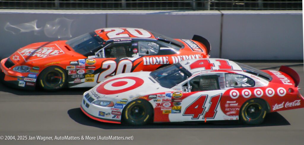 Two NASCAR race cars, number 20 with Home Depot branding and number 41 with Target branding, drive side by side on a racetrack.