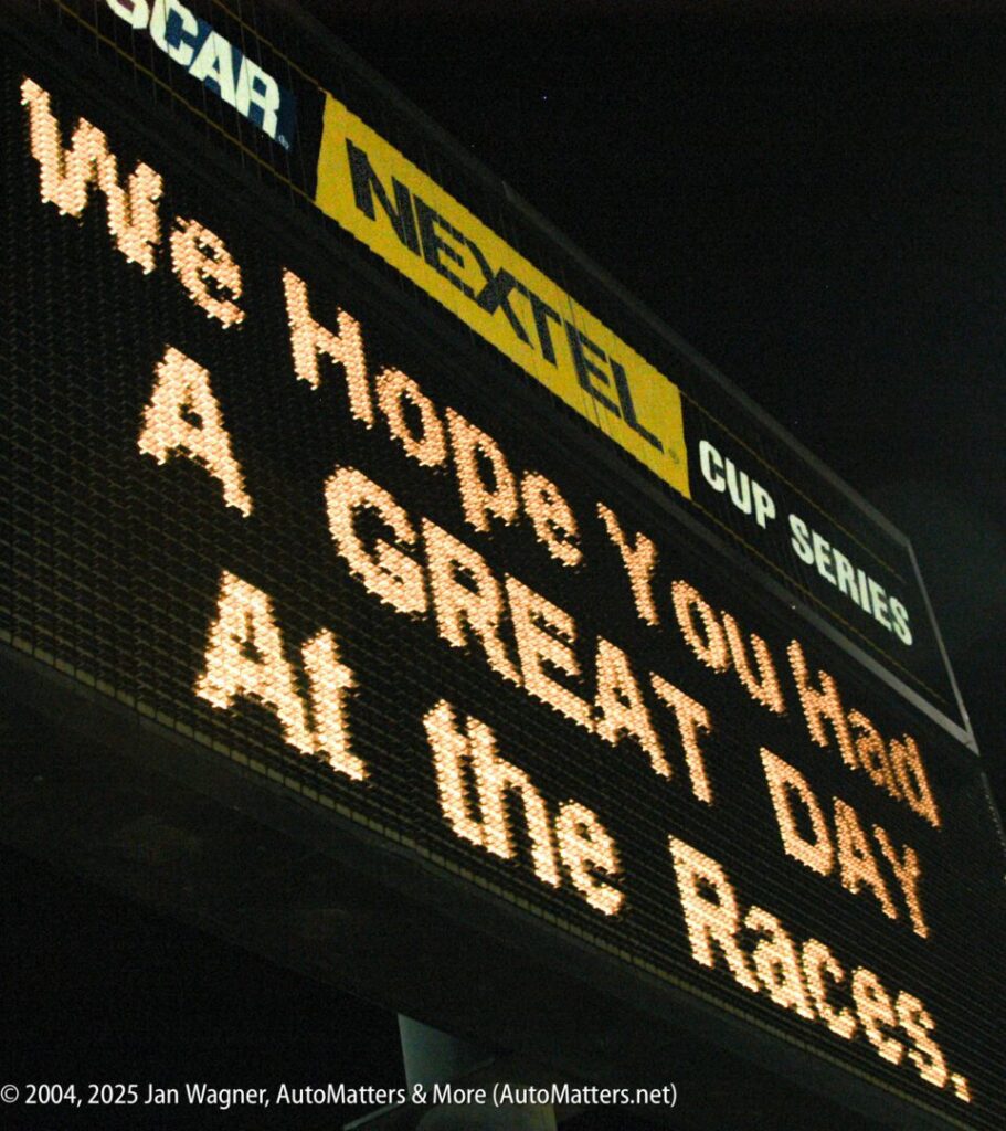 Large electronic sign at a racetrack reads: "We Hope You Had A GREAT DAY At the Races" with NASCAR and NEXTEL CUP SERIES logos above.