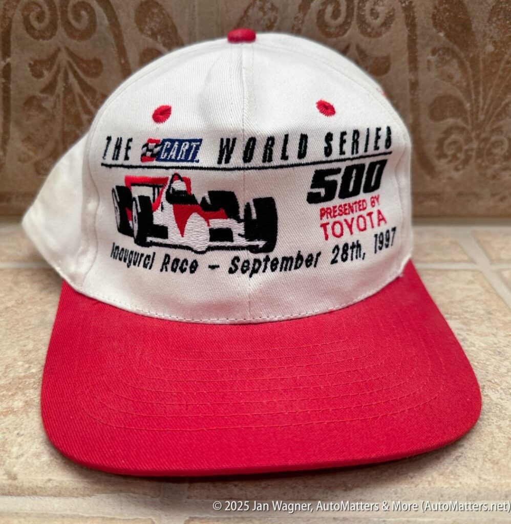 A white and red cap featuring the 1997 CART World Series 500 logo, an Indy car graphic, and race details presented by Toyota.