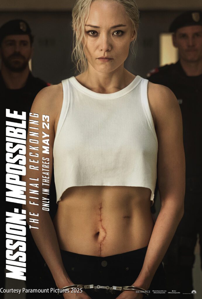 A woman with a visible abdominal scar stands in front of uniformed officers. Text on the left reads "Mission: Impossible – The Final Reckoning" and "In theatres May 23.