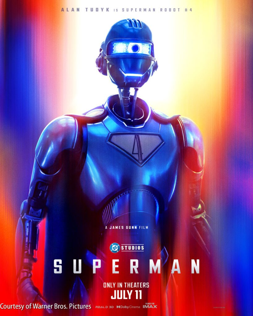 A humanoid robot with glowing blue eyes stands against a vibrant, colorful background; text promotes the film "Superman," releasing July 11.