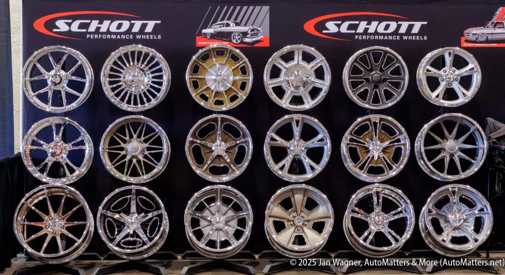 A display of fifteen Schott performance wheels arranged in three rows, with a Schott banner and car images in the background.