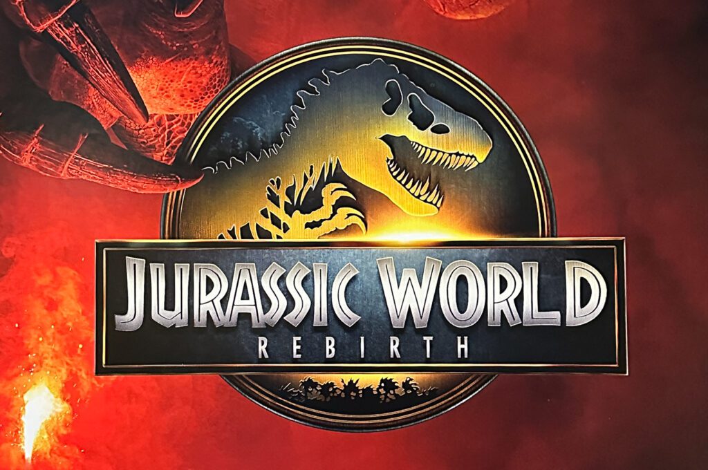 Jurassic World Rebirth logo featuring a dinosaur skeleton silhouette on a circular emblem, set against a red background.