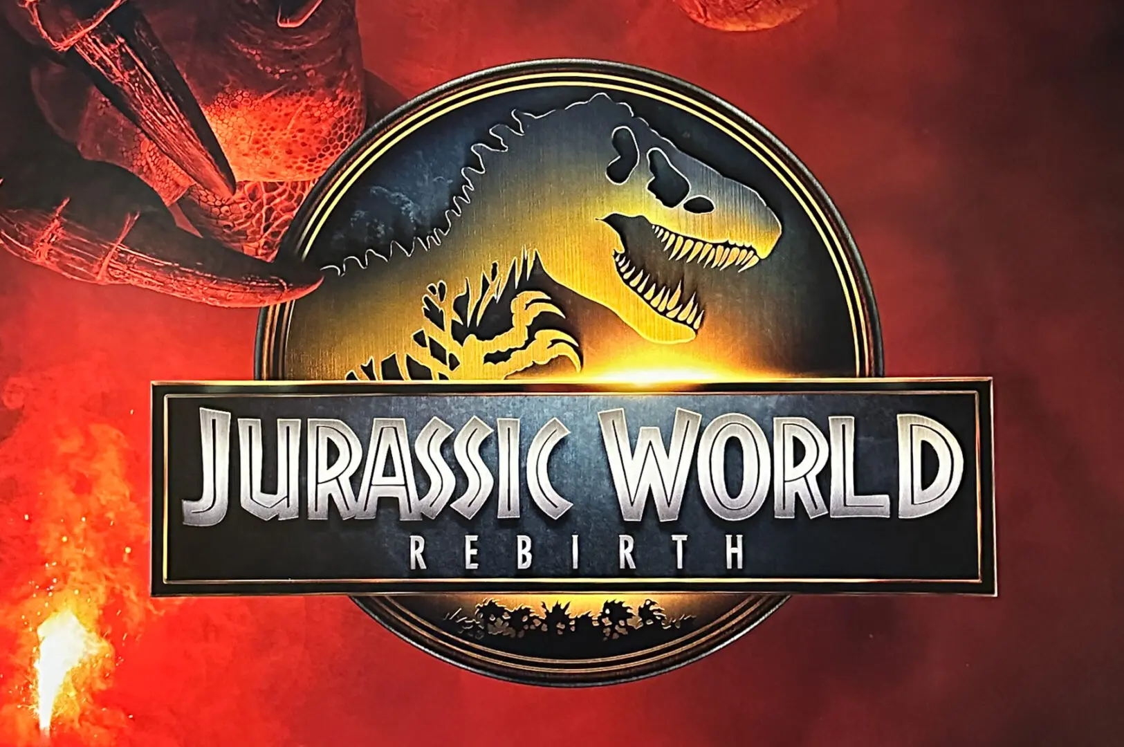 Jurassic World Rebirth logo featuring a dinosaur skeleton silhouette on a circular emblem, set against a red background.