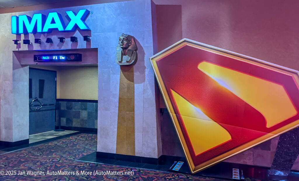 Entrance to an IMAX theatre featuring an Egyptian-style sculpture and a large Superman logo display in the hallway.