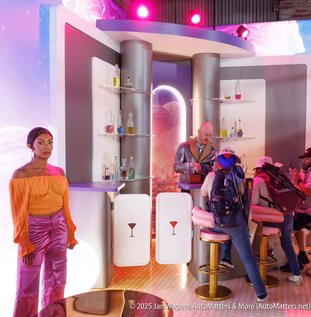 A group of people interact at a futuristic bar set with colorful bottles, while a woman in bright orange and purple clothing stands nearby.