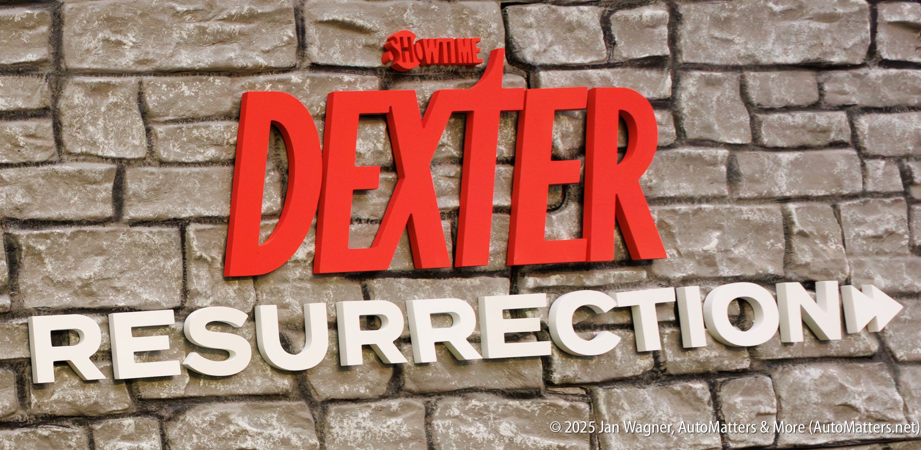 A stone wall with the words "SHOWTIME DEXTER RESURRECTION" in bold red and white letters.