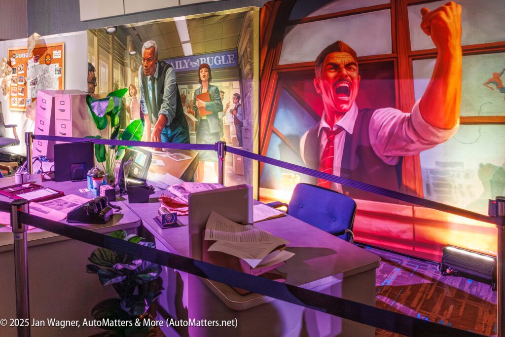 A staged office scene with scattered papers, desks, filing cabinets, and two large dramatic murals depicting animated characters in intense situations.