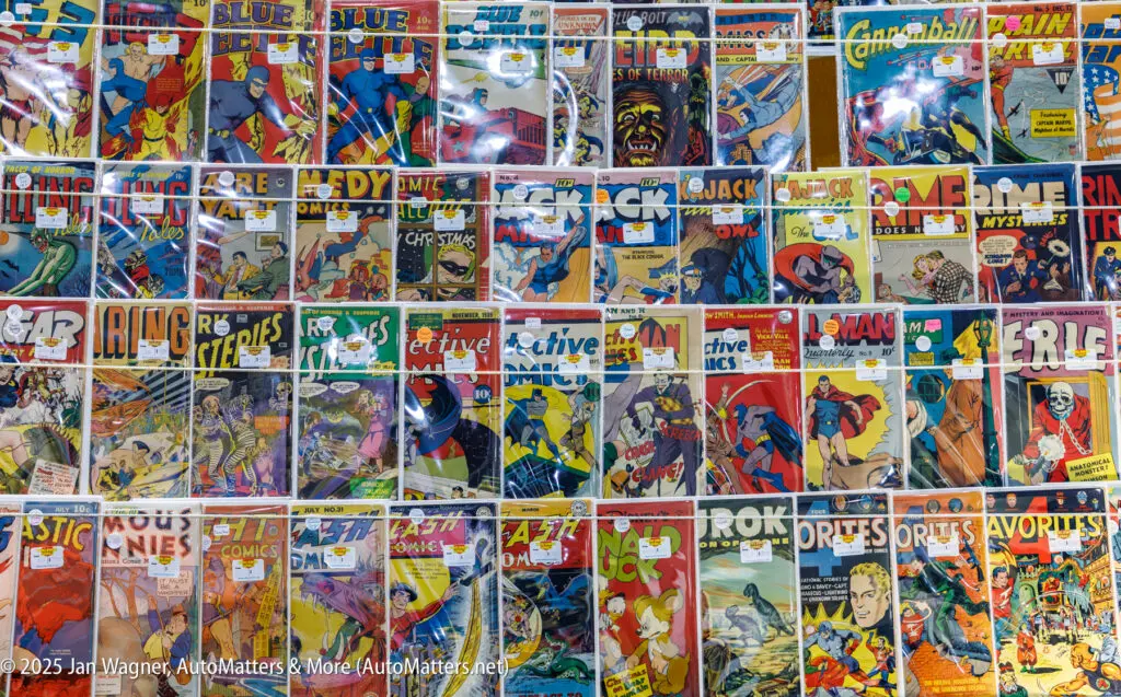 A display table with many colorful vintage comic books, each individually bagged and priced, arranged in a grid covering the entire surface.