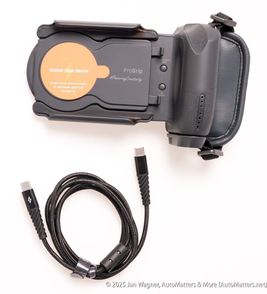 A black mobile gaming controller with a phone grip attachment, a “Center Your Device” sticker, and a coiled USB-C charging cable placed below it on a white background.
