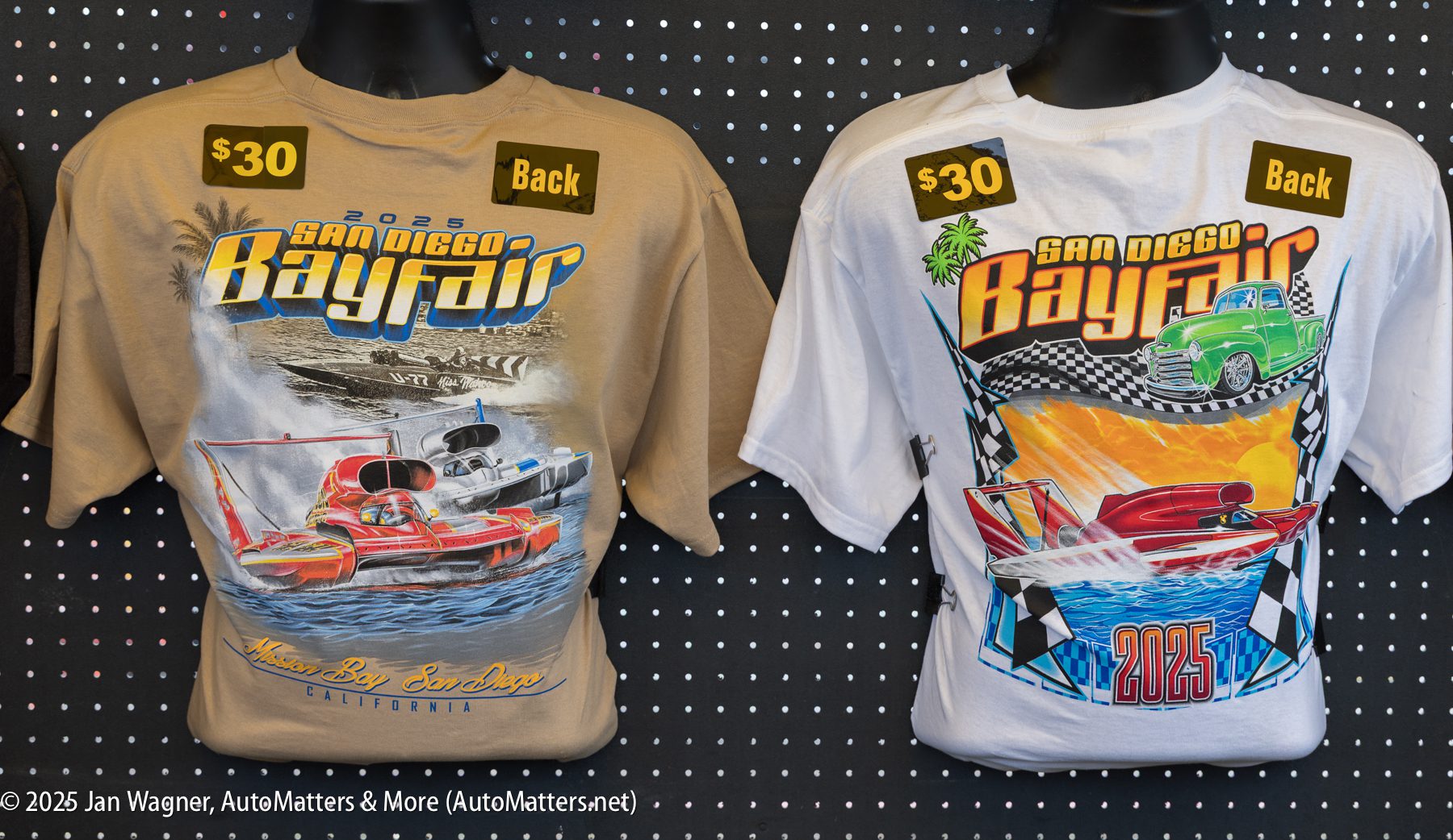 Two 2025 San Diego Bayfair t-shirts, one tan and one white, displayed on hangers with $30 price tags; each shirt features colorful speedboat graphics.