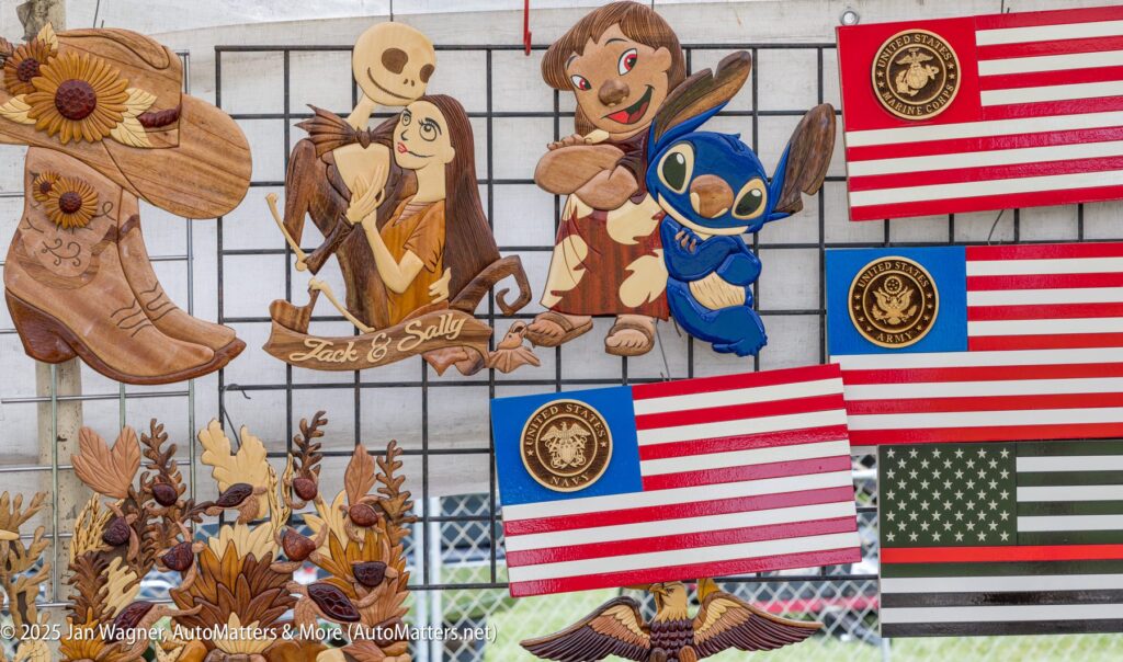 Wooden crafts on display, including characters from "The Nightmare Before Christmas" and "Lilo & Stitch," decorative American flags, boots, and floral designs.