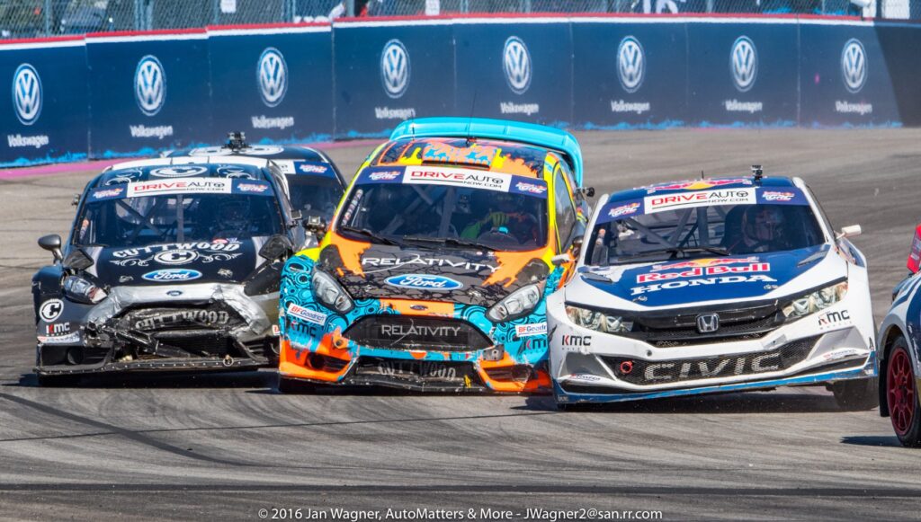 Three race cars collide on a track during a motorsport event, with visible damage to the front and sides of the vehicles.