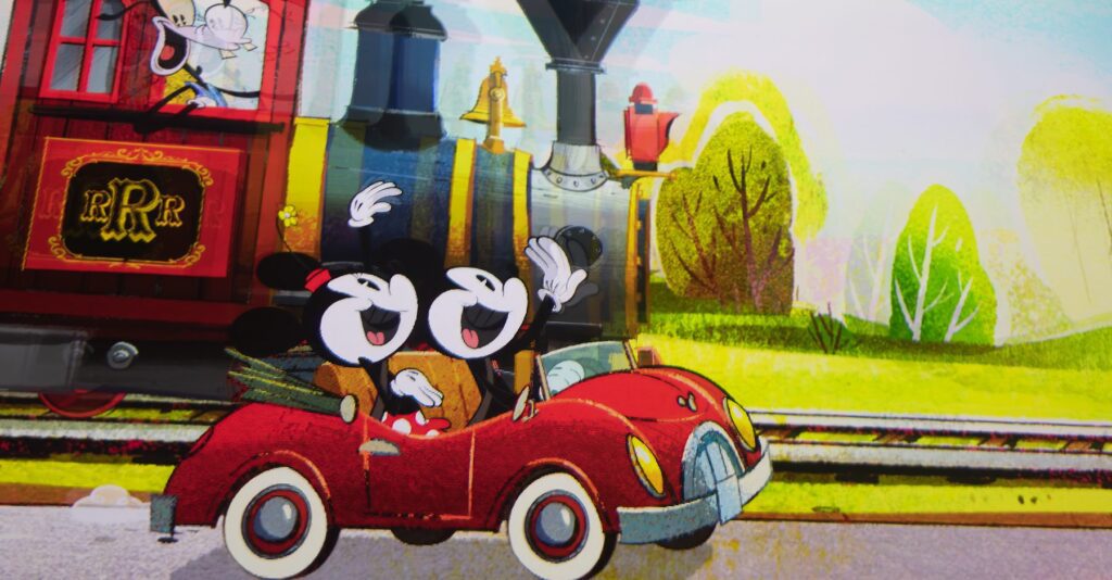 Two cartoon mice wave cheerfully from a red car in front of a train, with a colorful, animated landscape in the background.