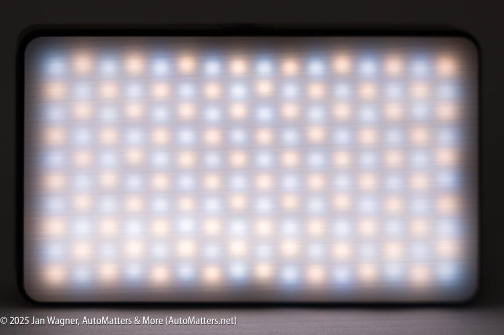 A rectangular LED light panel displaying a grid pattern of illuminated white and amber lights.
