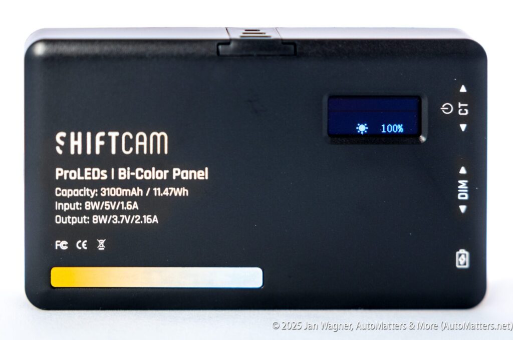 Rectangular ShiftCam ProLEDs Bi-Color Panel with display showing 100% battery, capacity and input/output specs printed on the front, and a color temperature indicator bar at the bottom.