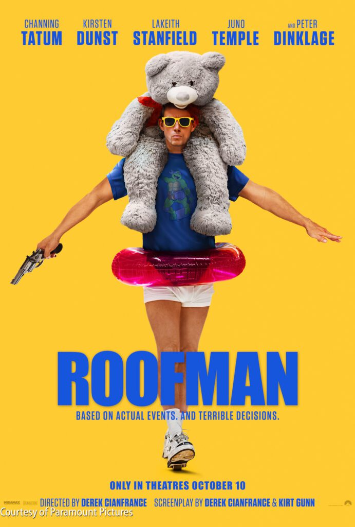 A man in sunglasses wearing a teddy bear costume on his shoulders, a pink swim ring, and holding a gun stands against a yellow background. Text on the image promotes the film "Roofman.