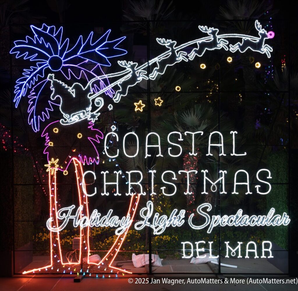 Neon sign featuring a palm tree with Santa and his sleigh overhead, reading "Coastal Christmas Holiday Light Spectacular Del Mar.