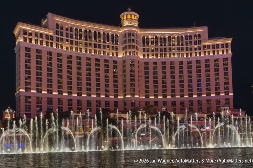 The Bellagio Hotel in Las Vegas is illuminated at night with its fountains spraying water in front of the building.