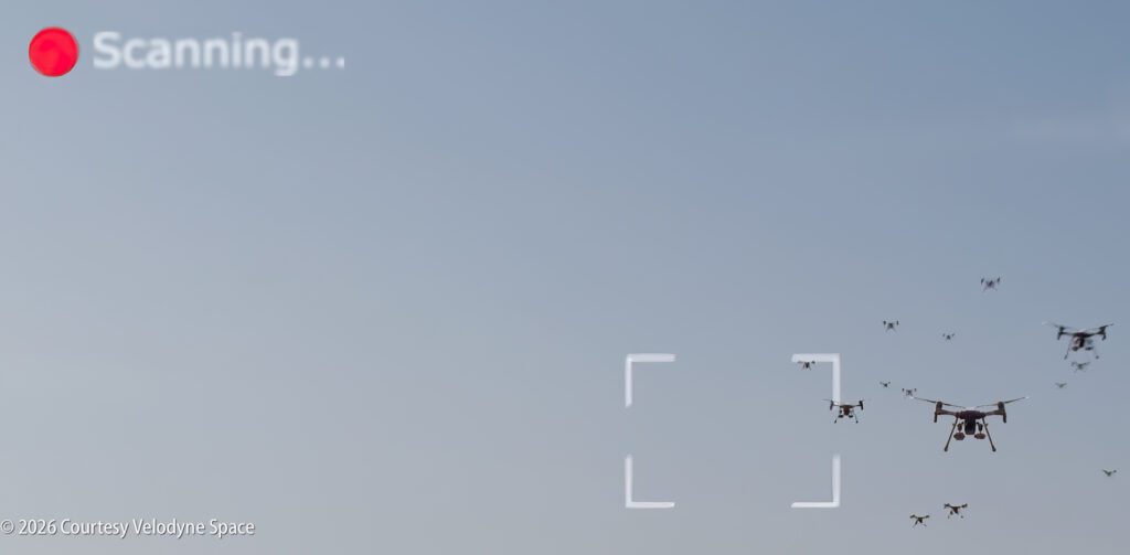 A group of drones flies in the sky, with a digital scanning overlay and a red "Scanning..." indicator in the top left corner.