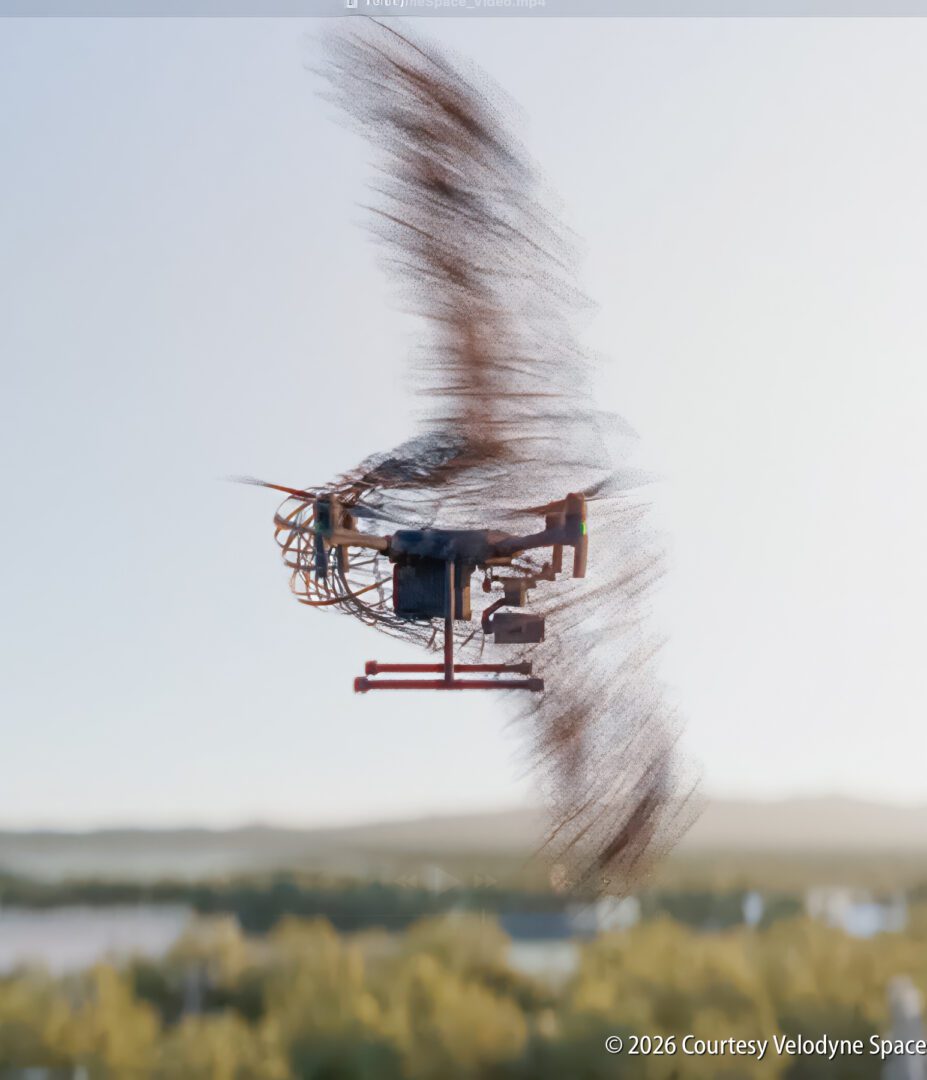A drone in flight with blurred rotors, capturing motion against a landscape background; © 2026 Courtesy Velodyne Space.