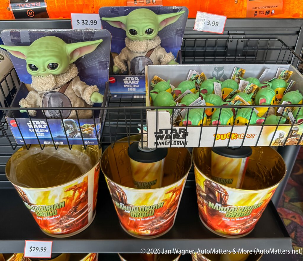 Star Wars Mandalorian merchandise display with plush Grogu dolls, Grogu rubber ducks, and collectible buckets on a store shelf.