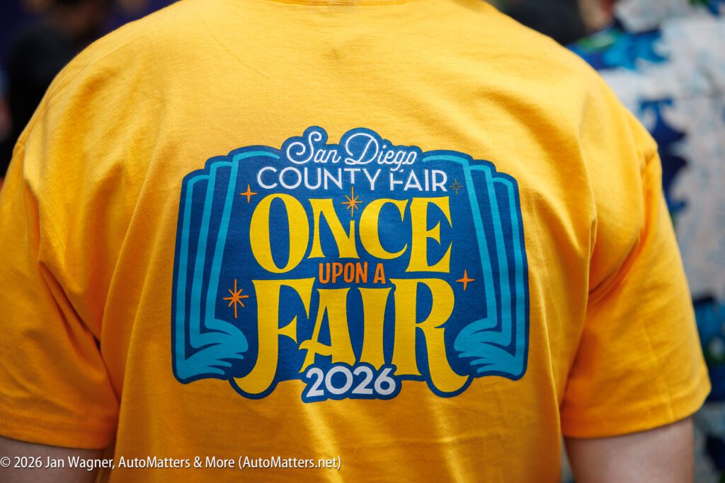 Person wearing a yellow T-shirt with "San Diego County Fair Once Upon a Fair 2026" printed on the back in blue and yellow lettering.