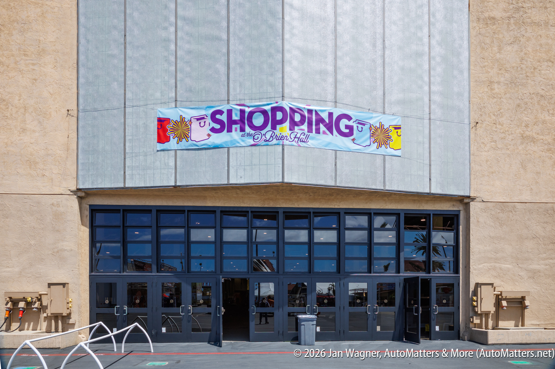 Entrance to a building with a large banner above the doors that reads "Shopping at the O'Brien Hall.