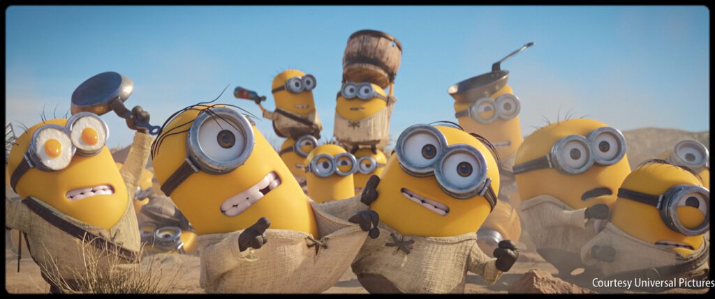 A group of Minions wearing makeshift outfits gather outdoors, some holding objects like pans and bottles, with surprised or confused expressions.