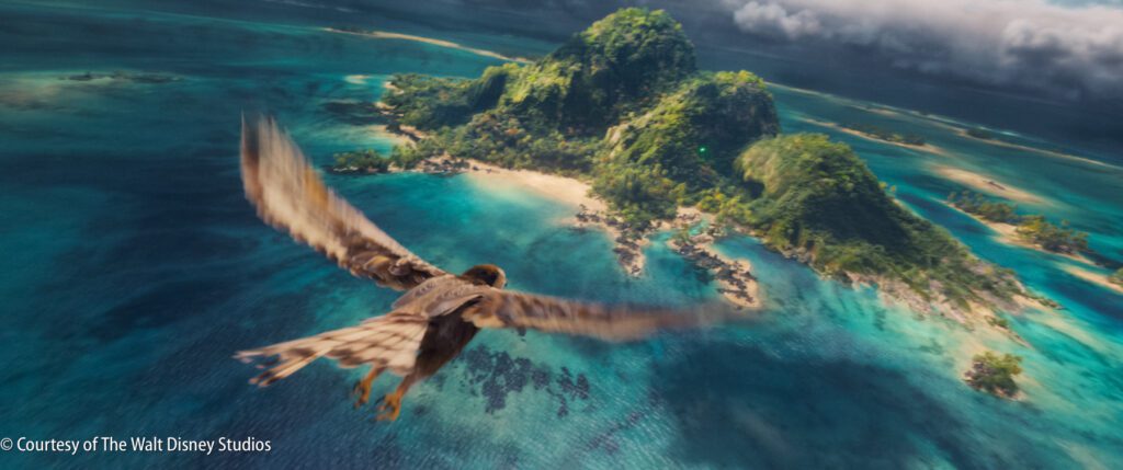 A bird flies over a turquoise ocean toward a lush, mountainous island under partly cloudy skies.