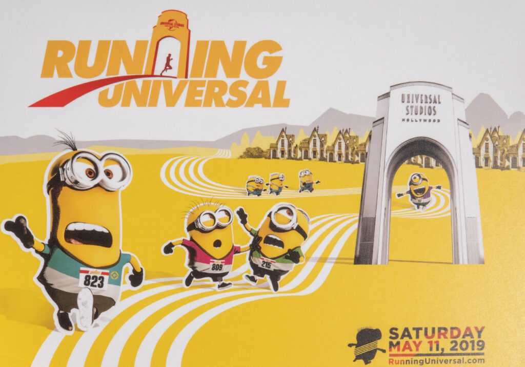 Illustration of Minions running a race through Universal Studios Hollywood with the text "Running Universal" and event date "Saturday May 11, 2019.