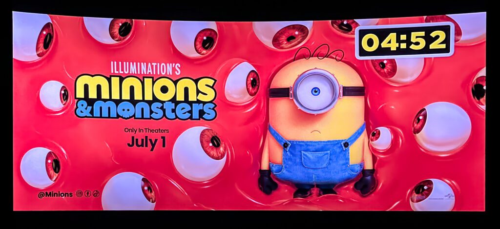 A Minion stands on a red background with monster eyes. Text reads "Minions & Monsters, Only in Theaters July 1." A countdown timer shows 04:52.