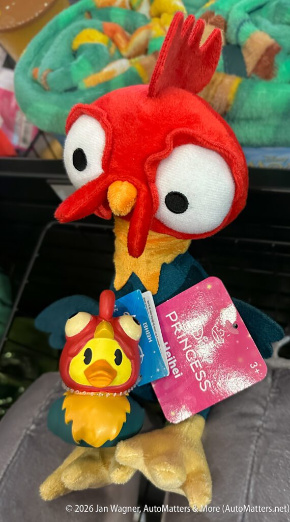 A plush toy and a small rubber toy of Hei Hei, the rooster from Disney’s Moana, sit on display with a pink Princess tag attached.