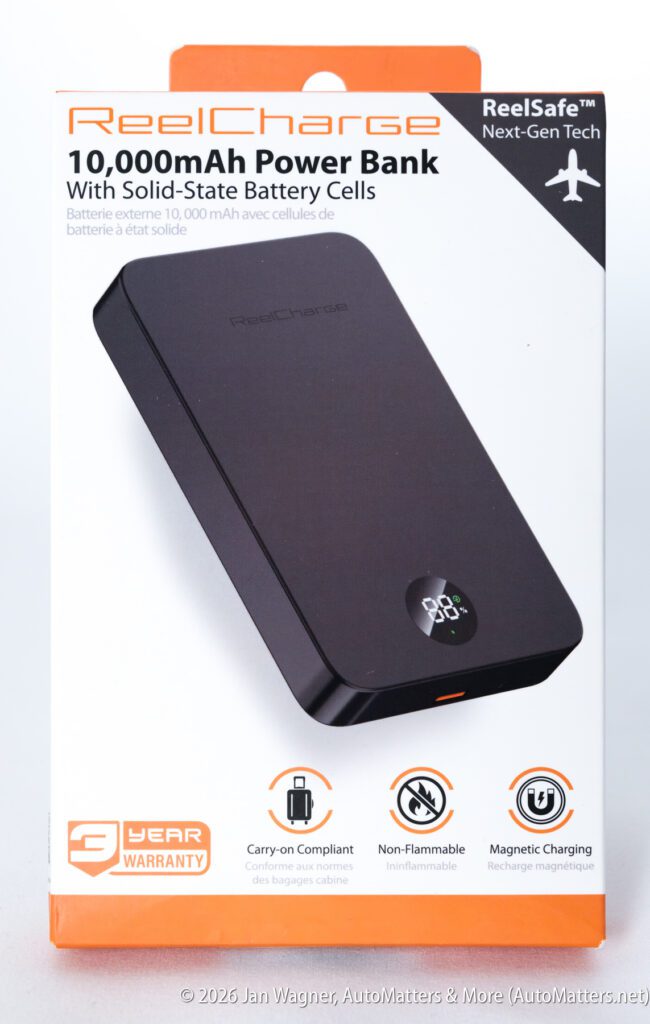 A black 10,000mAh ReelCharge power bank in retail packaging, featuring solid-state battery cells, magnetic charging, and a three-year warranty.