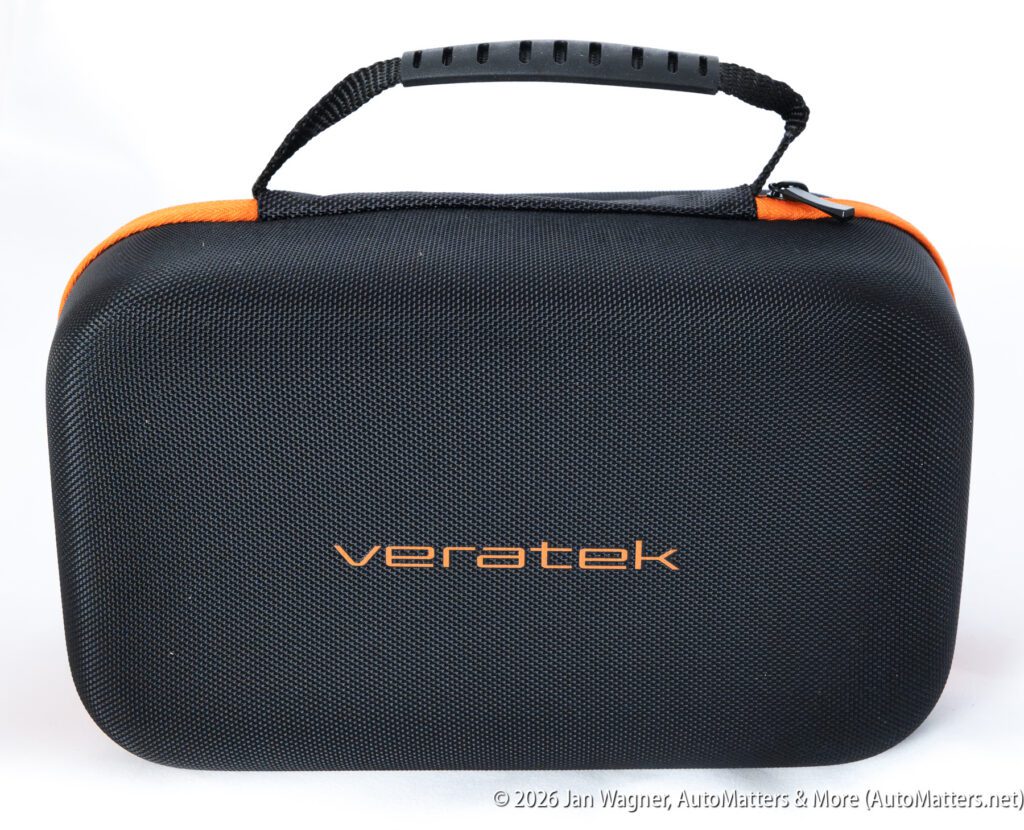A black, textured carrying case with an orange zipper, handle, and the word “veratek” printed on the front in orange letters.