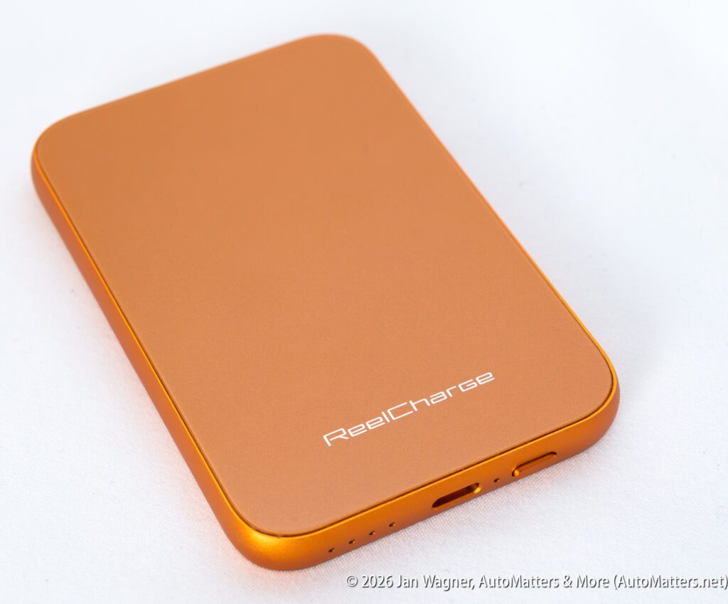Orange external hard drive labeled “ReelCharge” shown on a white background, with charging and data ports visible at the bottom edge.
