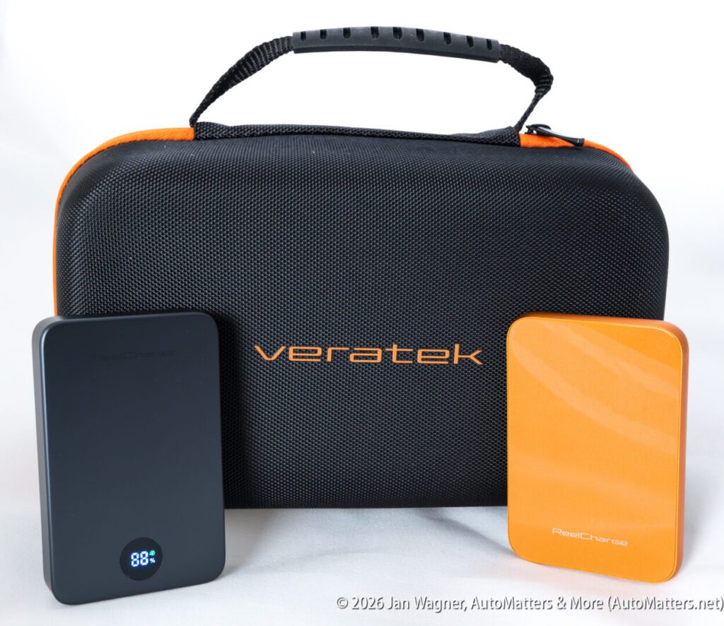 A black Veratek carrying case with two portable power banks, one black with a digital display showing 88%, and one orange, positioned in front.