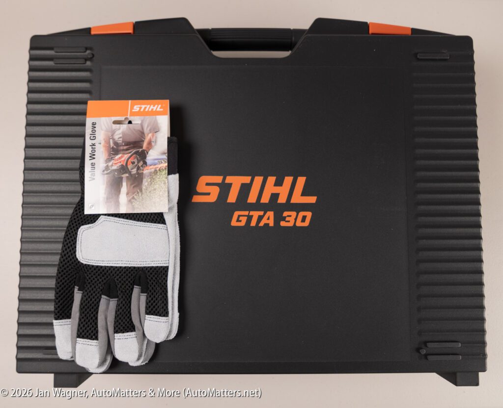 A STIHL GTA 30 case is shown with a pair of STIHL value work gloves placed on top, still attached to their packaging.